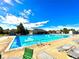 Large swimming pool with lounge chairs and clubhouse under a bright, sunny sky at 13560 Detroit St, Thornton, CO 80241