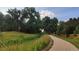 Scenic view of a paved walking path lined with trees and foliage at 13560 Detroit St, Thornton, CO 80241