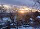 Stunning sunset view over snowy landscape, houses and a backyard pool visible at 4618 S Newton St, Denver, CO 80236