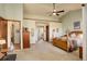 Main bedroom with vaulted ceiling, wood furniture, and access to bathroom at 4618 S Newton St, Denver, CO 80236