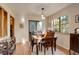 Bright dining room features hardwood floors and a wood table with chairs at 4618 S Newton St, Denver, CO 80236