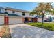 Two-story brick townhouse with attached garage and front yard at 4618 S Newton St, Denver, CO 80236