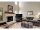 Living room with hardwood floors, fireplace, and a gray couch at 4618 S Newton St, Denver, CO 80236