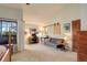 Home office with a desk, chair, and gray sofa near sliding barn door at 4618 S Newton St, Denver, CO 80236