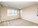 Sun-filled bedroom with a large window, carpeted floor, and a bright, airy atmosphere at 8596 Hotchkiss St, Littleton, CO 80125