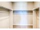 Spacious walk-in closet with ample storage space and metal hanging rods at 8596 Hotchkiss St, Littleton, CO 80125