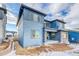 Modern two-story home featuring blue siding, stone accents, and a covered porch at 8596 Hotchkiss St, Littleton, CO 80125