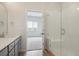 Bright bathroom with single vanity, walk-in shower, and view to bedroom at 487 Interlocken Blvd # 407, Broomfield, CO 80021