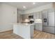 Modern kitchen with stainless steel appliances and an island at 487 Interlocken Blvd # 407, Broomfield, CO 80021