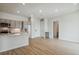 Open concept living area with kitchen and hardwood floors at 487 Interlocken Blvd # 407, Broomfield, CO 80021