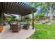 Inviting backyard patio featuring a pergola, fire pit, and ample seating at 5185 W Fair Pl, Littleton, CO 80123