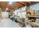 Unfinished basement with a utility sink, workbench, and ample storage space at 5185 W Fair Pl, Littleton, CO 80123