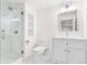 Bright bathroom featuring a glass shower, white vanity, and modern fixtures at 5185 W Fair Pl, Littleton, CO 80123