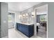 Bathroom featuring a double vanity with blue cabinets, and a view into the bedroom at 5185 W Fair Pl, Littleton, CO 80123