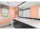 Well-lit bathroom featuring double sinks, quartz countertops, and modern fixtures at 5185 W Fair Pl, Littleton, CO 80123