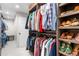 Walk-in closet featuring custom shelves and clothing racks with natural lighting at 5185 W Fair Pl, Littleton, CO 80123