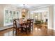Open-concept dining room connected to a cozy living room with fireplace, and bright natural light at 5185 W Fair Pl, Littleton, CO 80123