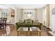 Elegant living room showcasing a green sofa, large window, and classic decor at 5185 W Fair Pl, Littleton, CO 80123