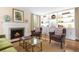 Cozy living room featuring a white fireplace, bookshelves, and comfortable seating at 5185 W Fair Pl, Littleton, CO 80123