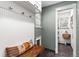 Functional mudroom with bench seating, storage hooks, and access to a pantry at 5185 W Fair Pl, Littleton, CO 80123