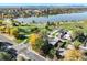 Stunning aerial shot of homes near Sloan's Lake, with vibrant fall foliage and the city skyline in the distance at 1901 Meade St, Denver, CO 80204