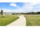 Scenic view of a paved walking path through a grassy area near Sloan's Lake, under a partly cloudy blue sky at 1901 Meade St, Denver, CO 80204
