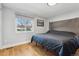 Bright bedroom featuring a king-size bed and wood flooring at 7825 S Marshall St, Littleton, CO 80128