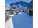 Cozy backyard featuring wood deck stairs, metal storage, and detached garage at 313 W 3Rd Ave, Byers, CO 80103