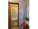 The bathroom has a toilet, wood accents and a view of the bathtub and curtain at 313 W 3Rd Ave, Byers, CO 80103