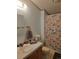 Small bathroom with wood vanity and shower tub with curtain at 313 W 3Rd Ave, Byers, CO 80103