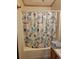Bathroom featuring a tub and shower with curtain, and a light blue color palette at 313 W 3Rd Ave, Byers, CO 80103