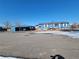 Charming home featuring a spacious carport, painted in a coordinated blue tone at 313 W 3Rd Ave, Byers, CO 80103