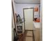 Laundry room featuring a washer and dryer, storage, and a white door to the outside at 313 W 3Rd Ave, Byers, CO 80103