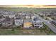Aerial view showcases homes with fenced yards in a neighborhood with picturesque scenery at 18922 W 84Th Ave, Arvada, CO 80007