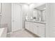 Bathroom with dual sinks and granite countertop vanities offering plenty of storage space at 18922 W 84Th Ave, Arvada, CO 80007
