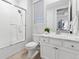 Bathroom features a shower with glass door, toilet, and single sink vanity at 18922 W 84Th Ave, Arvada, CO 80007