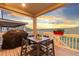 Outdoor deck area features a patio table, chairs, grill, and scenic mountain views at 18922 W 84Th Ave, Arvada, CO 80007