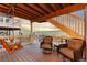 Cozy covered deck with comfortable seating, a porch swing, and stunning mountain views at 18922 W 84Th Ave, Arvada, CO 80007