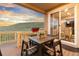 Covered deck features a patio table, chairs, flower box, and sliding glass doors to the dining room at 18922 W 84Th Ave, Arvada, CO 80007