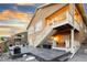 Home's exterior features a patio, a staircase leading up to a deck, and professional landscaping at 18922 W 84Th Ave, Arvada, CO 80007