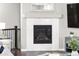 Close up of the fireplace featuring white marble tile and decorative mantle at 18922 W 84Th Ave, Arvada, CO 80007