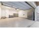 Clean garage with epoxy flooring, storage cabinets, and ample space for vehicles and projects at 18922 W 84Th Ave, Arvada, CO 80007