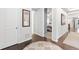 Bright hallway featuring hardwood floors, white trim, and neutral wall color at 18922 W 84Th Ave, Arvada, CO 80007