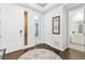 Hallway featuring hardwood floors, white trim, neutral wall color, and doors at 18922 W 84Th Ave, Arvada, CO 80007