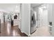 View of kitchen and dining area, stainless steel fridge, and access to the dining room at 18922 W 84Th Ave, Arvada, CO 80007