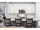 Close view of the kitchen island featuring white cabinets and pendant lighting at 18922 W 84Th Ave, Arvada, CO 80007