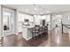 Bright kitchen features white cabinetry, granite counters, stainless appliances, and bar seating at 18922 W 84Th Ave, Arvada, CO 80007