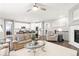 Open concept living room with plush furnishings, fireplace, and connection to the kitchen at 18922 W 84Th Ave, Arvada, CO 80007