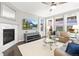 Light filled living room showcases a fireplace, plush seating, and views from large windows at 18922 W 84Th Ave, Arvada, CO 80007