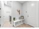 Welcoming mudroom with storage bench, coat hooks, and access to laundry room for added convenience at 18922 W 84Th Ave, Arvada, CO 80007